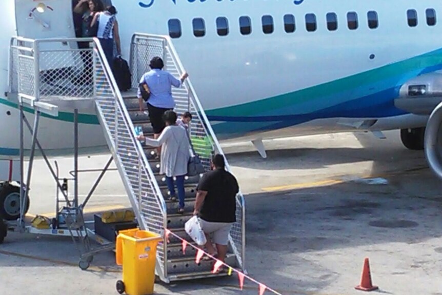 Nauru MSF workers board a plane to leave the island.