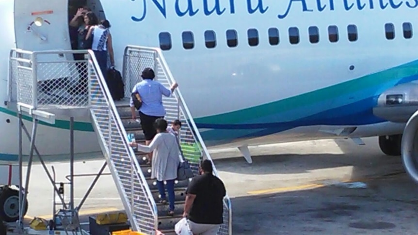 Nauru MSF workers board a plane to leave the island.