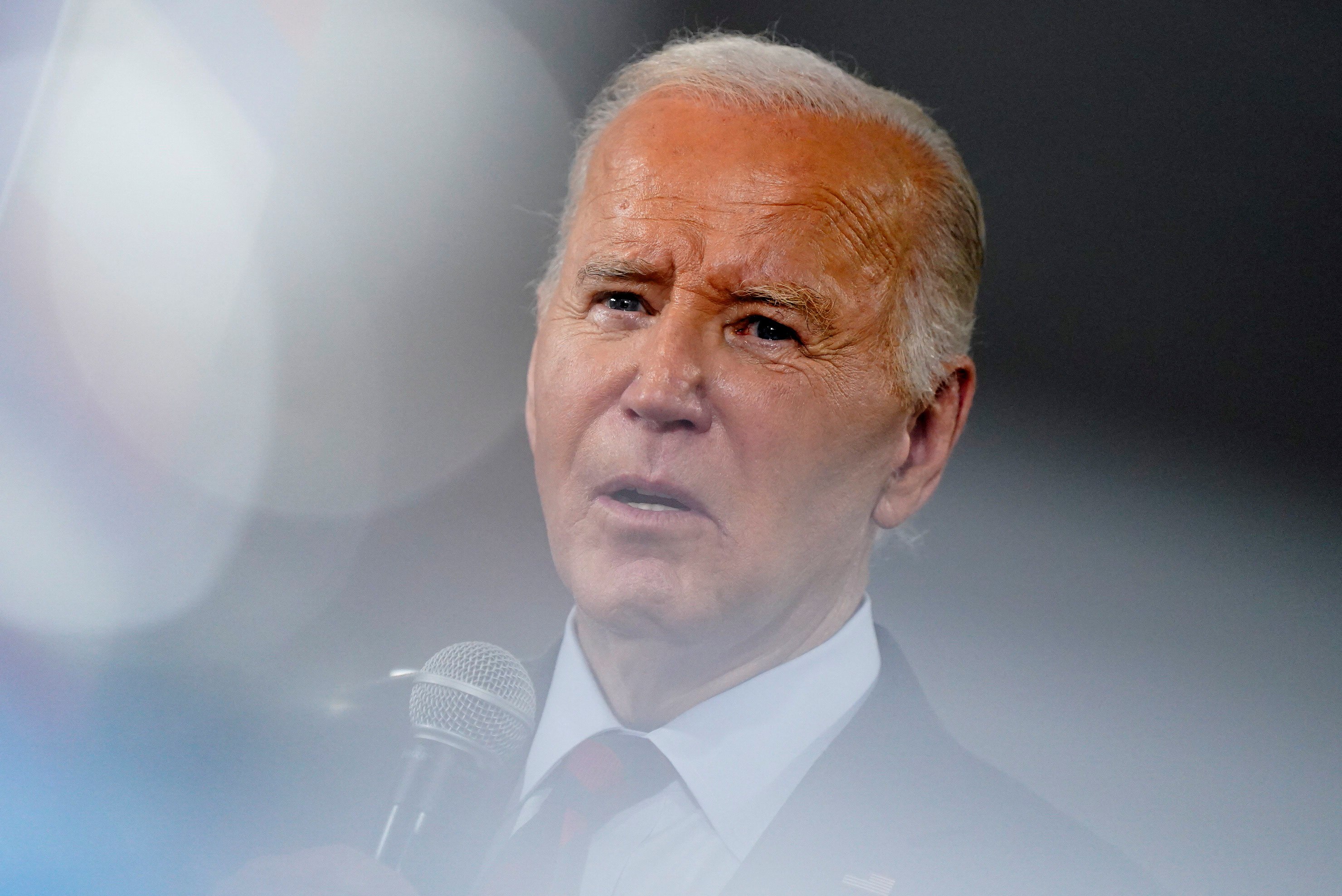 Biden speaks in close up with his skin looking slightly orange