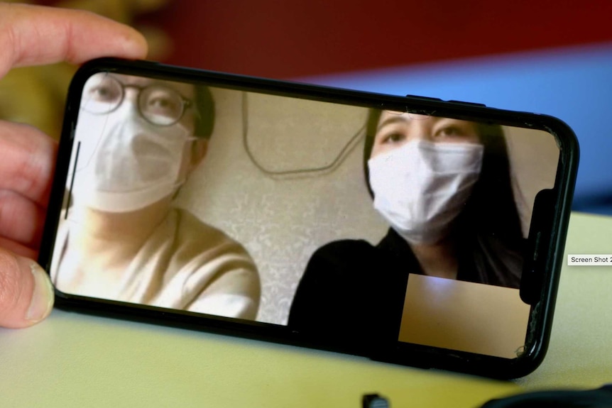 Wu Di and Peng Jing are on a phone screen during an interview.