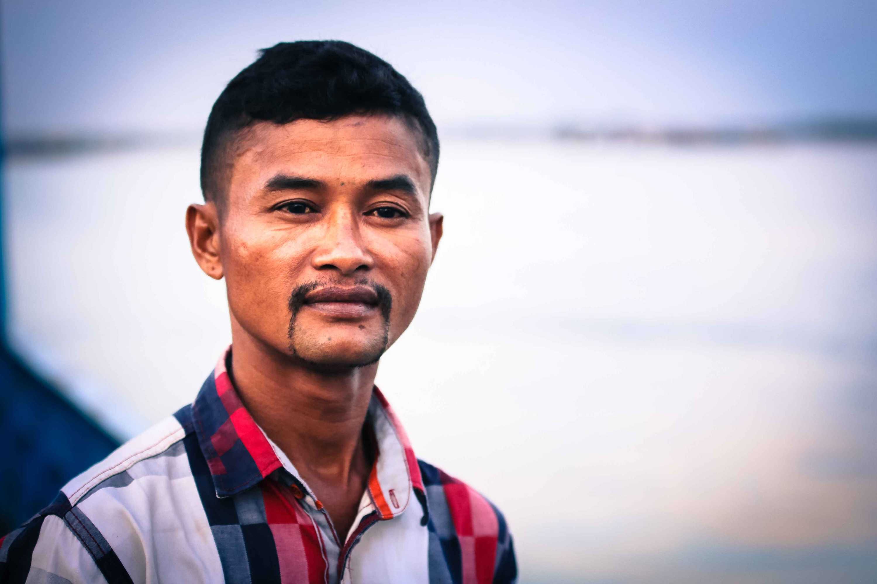 Headshot of Vannak Prum, looking off into the distance.