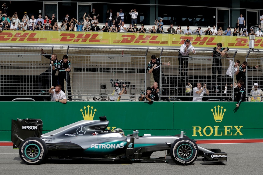 Mercedes crew celebrates as Lewis Hamilton wins US Grand Prix