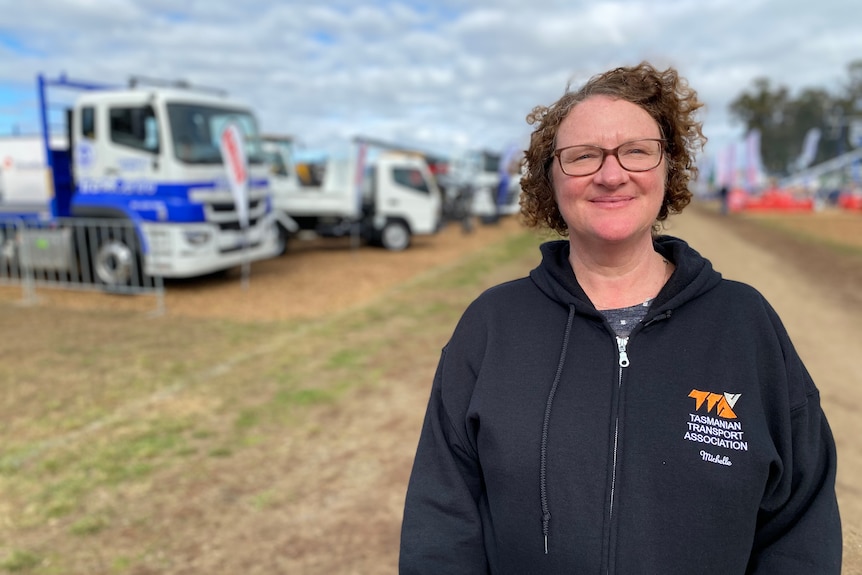 Tasmanian Transport Association executive director Michelle Harwood stands in front of trucks at AgFest