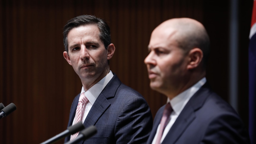 Senator Simon Birmingham listens to Josh Frydenberg speak