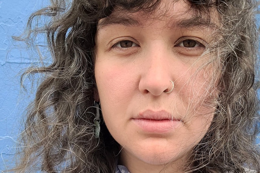 A close-up photo of Mary McCloskey, a young woman with curly hair.