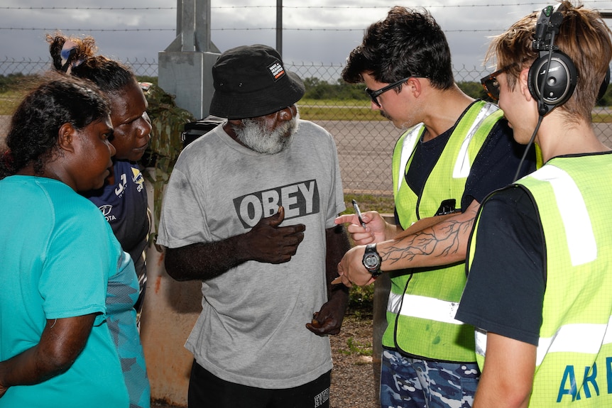 Royal Australian Air Force personnel with Borroloola community members before their evacuation flight to Darwin.