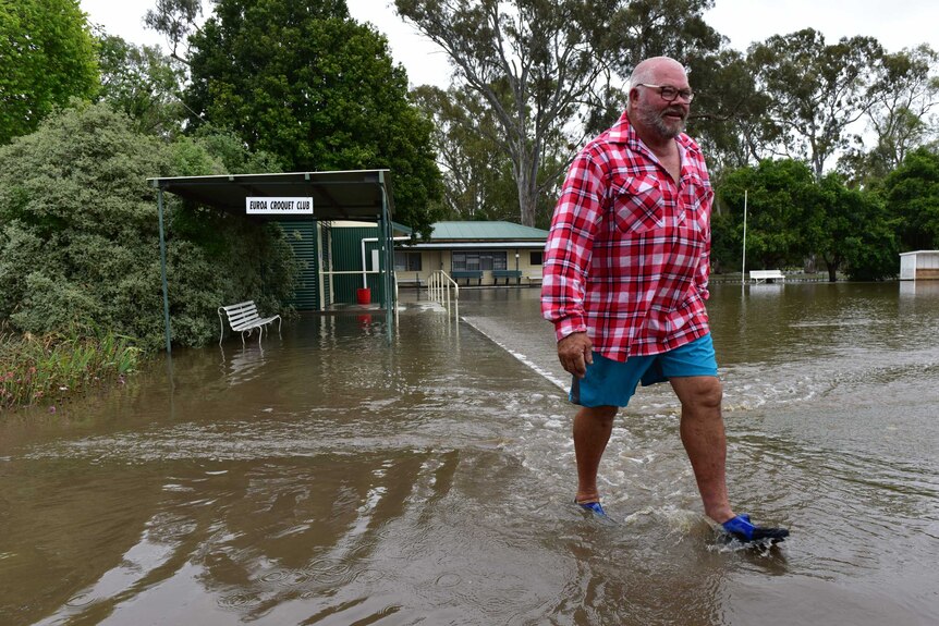 A local resident walks through floodwater in Euroa, Victoria.