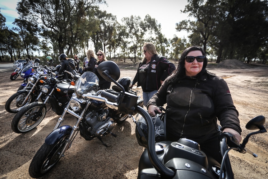 A group of female riders with the carmen Conway-Hicks sitting on her bike at the front.