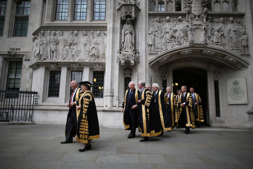 A group of judges walk from the UK Supreme Court