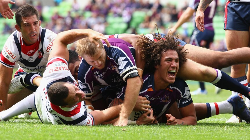 Kevin Proctor barges through the weak Roosters defence to score.