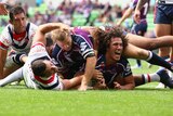 Kevin Proctor barges through the weak Roosters defence to score.