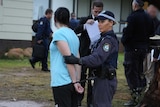 A woman arrested in Raye Street in the Wagga Wagga suburb of Tolland as part of the NSW Police Force's Strike Force Calyx.