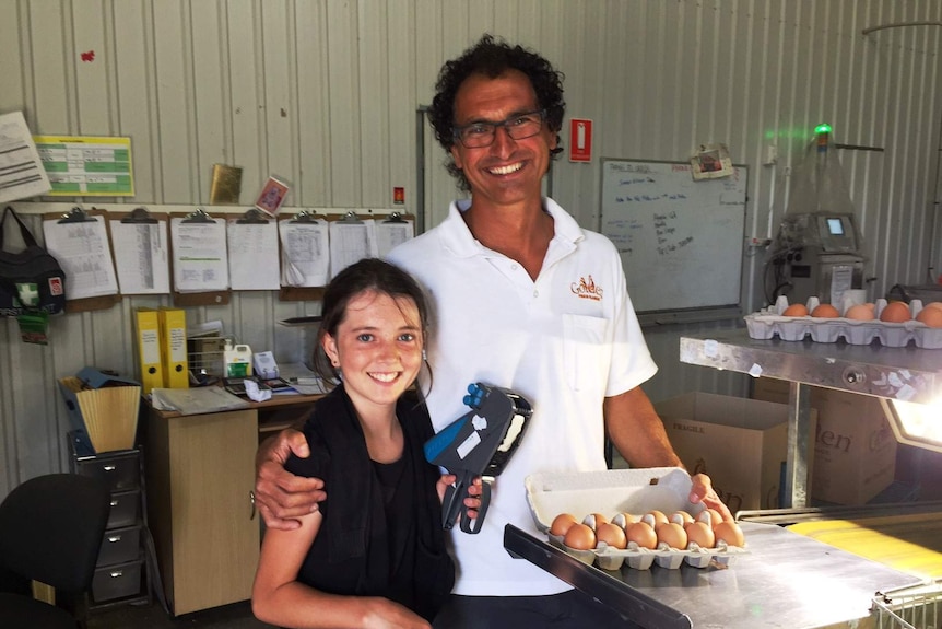 A man and his daughter with some eggs