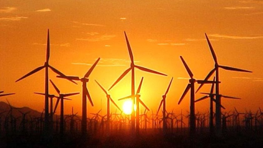 Generic pic of wind turbines against a sunset at a wind farm in the United States.