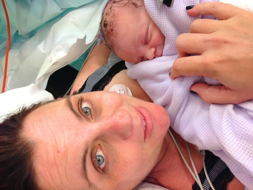 A woman with a newborn baby in hospital