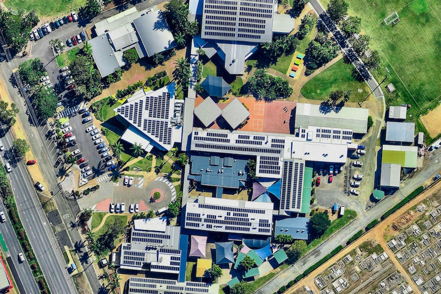 an aerial of a school with solar panels