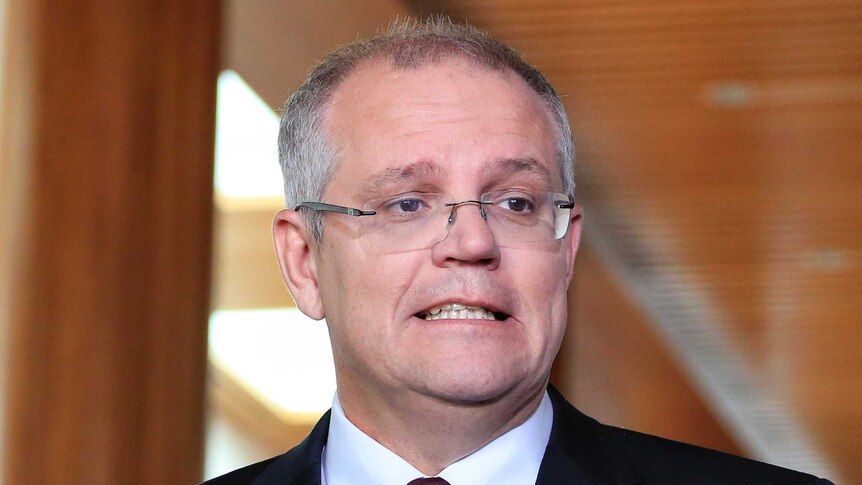 Scott Morrison pulls a face while speaking to reporters