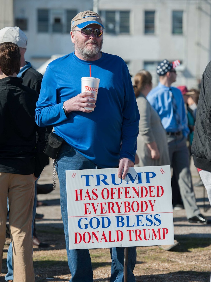A Donald Trump supporter joins a rally at Millington Regional Jetport in Millington, Tennessee, February 27, 2016.