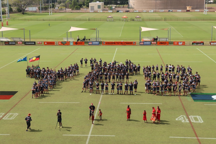 A crowd of Voice to Parliament supporters gathered in Darwin to spell out 'Yes' on a football field