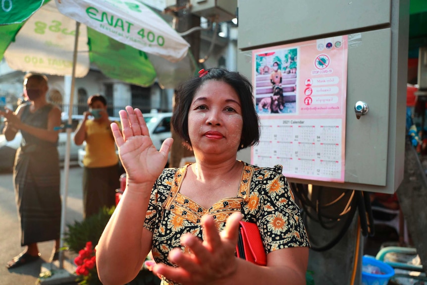 Woman claps hands in front of camera.