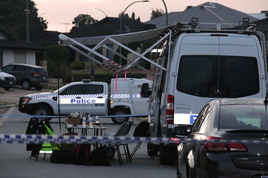 A police vehicle and a police incident control van parked on a suburban Perth street with police tape and a table and chairs.