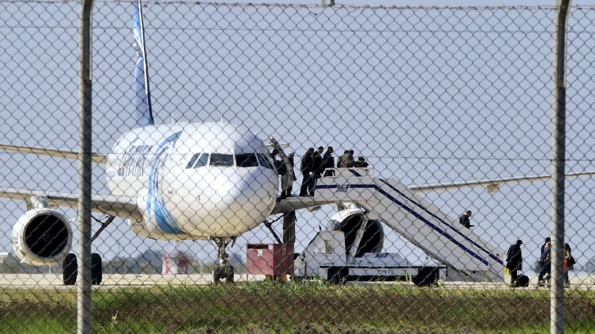 Passengers evacuate a hijacked EgyptAir Airbus 320 plane at Larnaca airport, Cyprus.