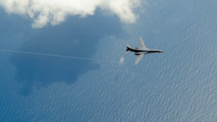 A B-1B Lancer from Dyess Air Force Base, Texas flies over the sea