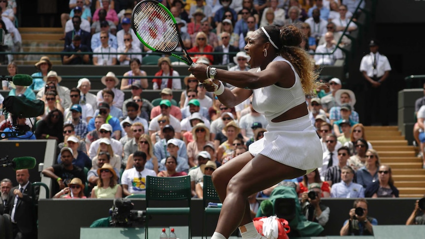 Serena Williams strains as she hits a powerful backhand on the Wimbledon courts