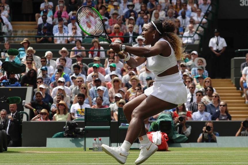 Serena Williams strains as she hits a powerful backhand on the Wimbledon courts