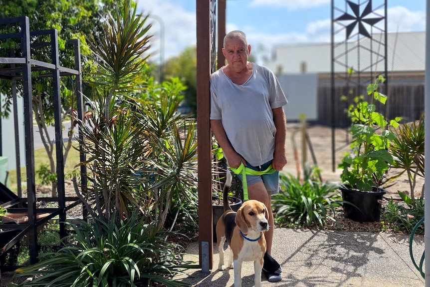 George Parkyn, who is experiencing housing stress, and dog in the garden