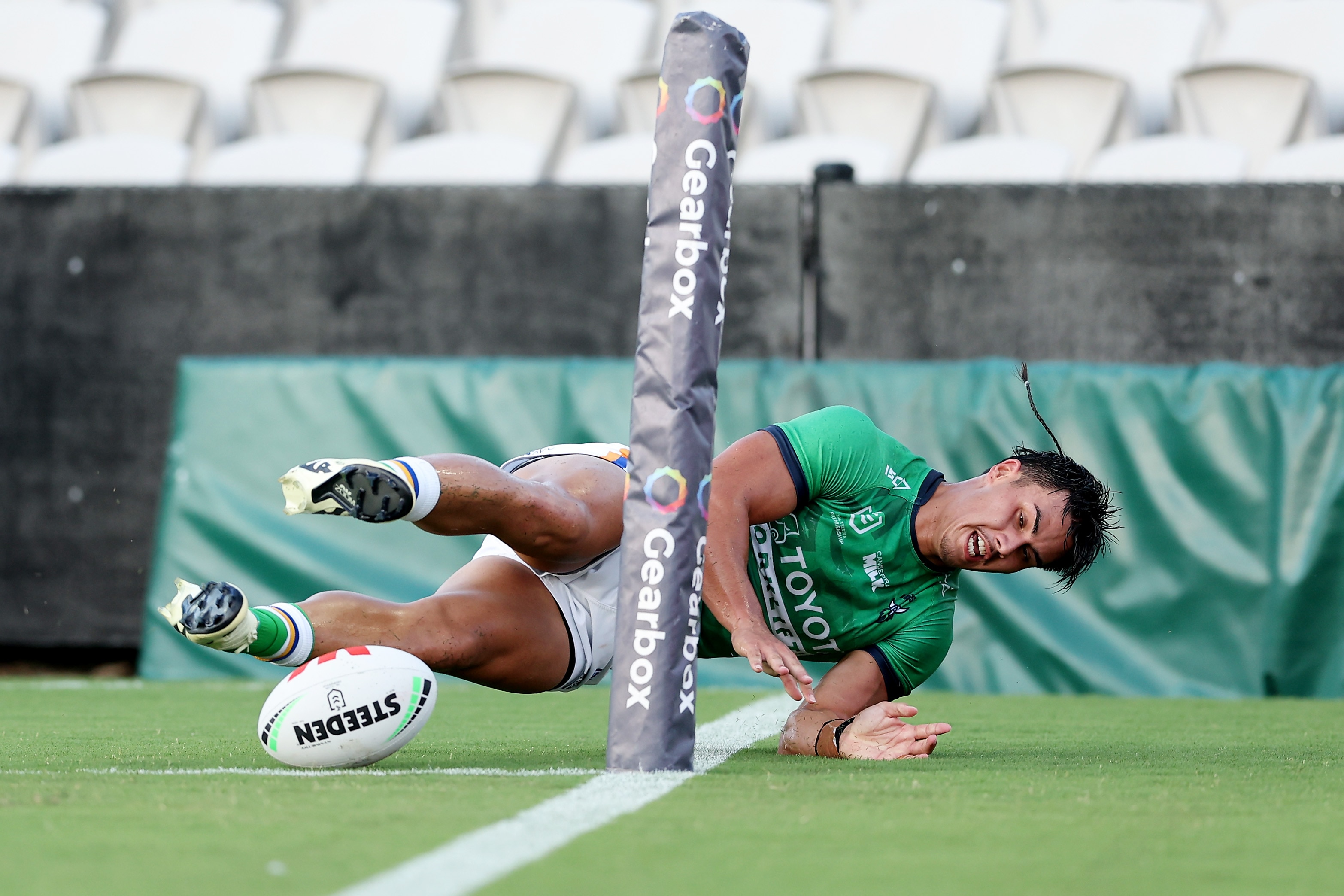 A man scores a try in the corner during a rugby league match 