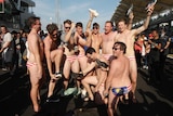 Australian men celebrate in swimwear decorated with the Malaysian flag at the grand prix