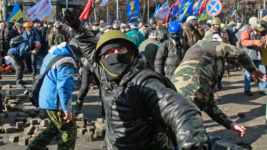 Protesters throw stones in Kiev