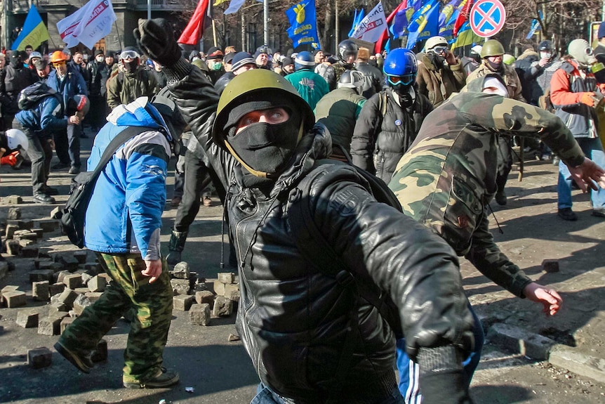 Protesters throw stones in Kiev