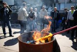 A Ukrainian flag burns outside city hall in Mariupol