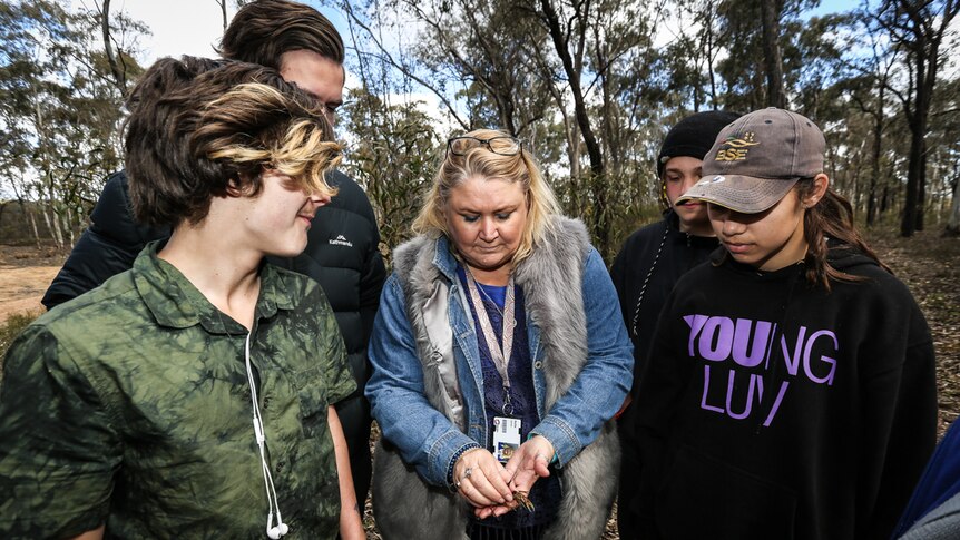 Teacher Kellie Jones surrounded by four TAFE students at the Greater Bendigo National Park.