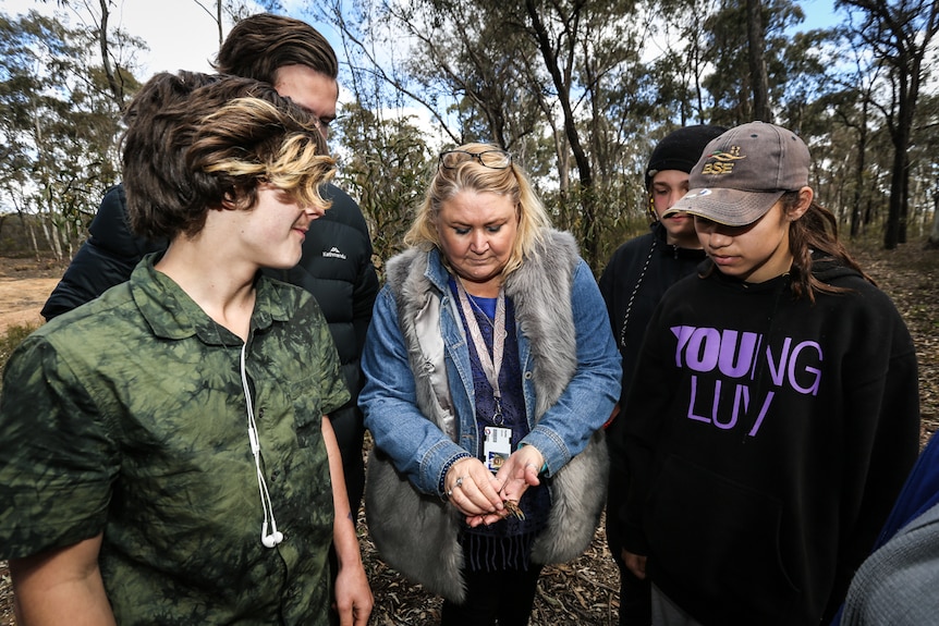 Teacher Kellie Jones surrounded by four TAFE students at the Greater Bendigo National Park.