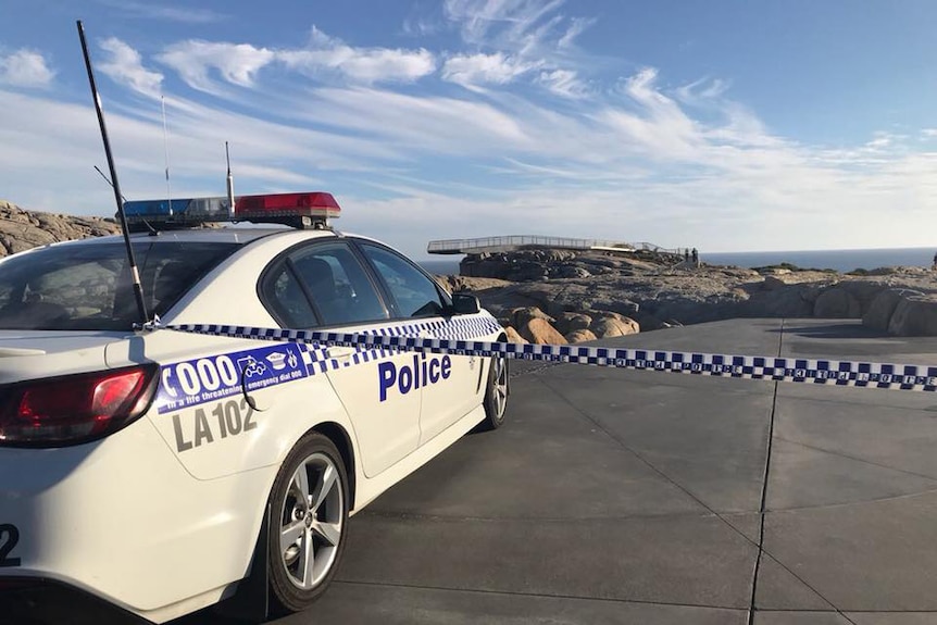 A polic car with a line of police tape closes off the viewing platform at The Gap.