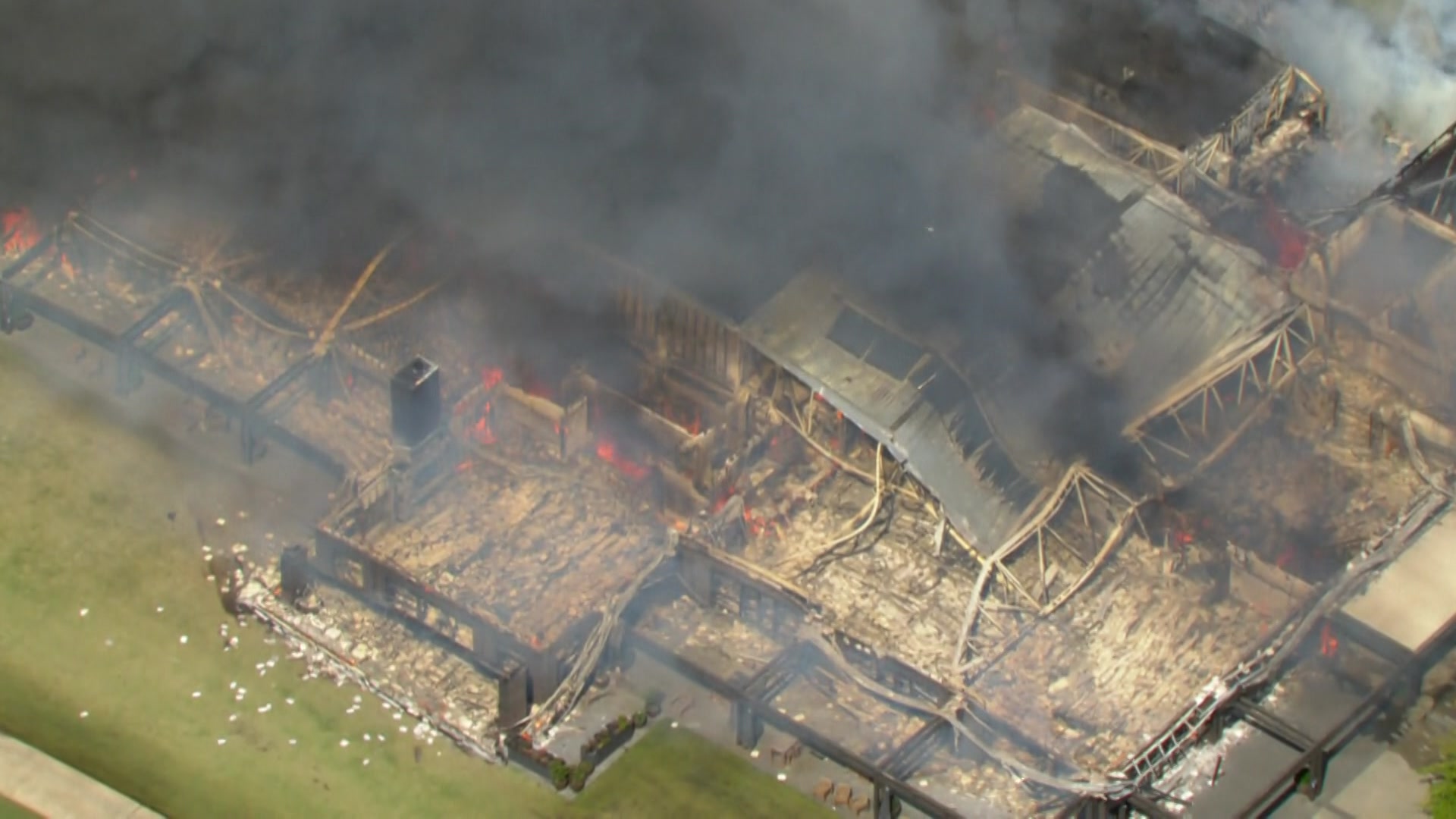 A building on fire at a golf course