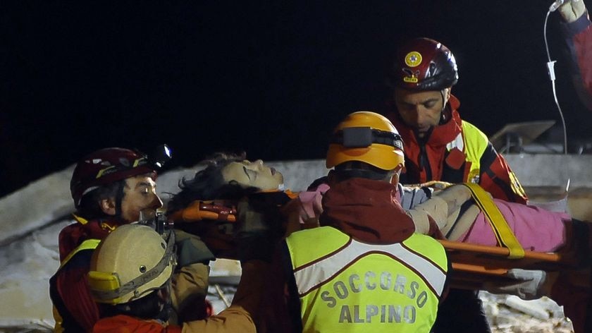 Rescuers work into the night: A woman is discovered alive 20 hours after the earthquake hit the L'Aquila region.