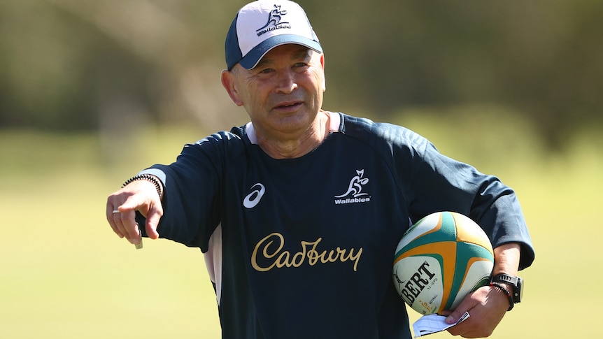 A rugby coach gestures during a training session