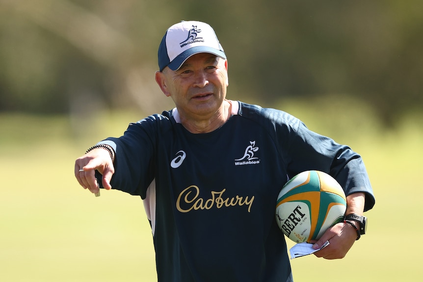 A rugby coach gestures during a training session
