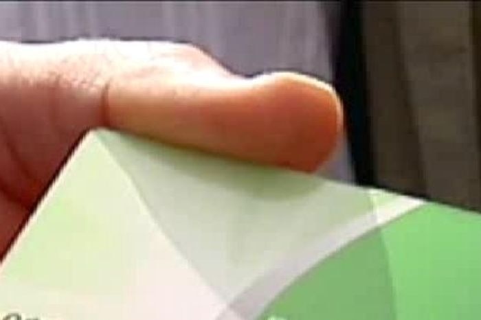 Hand holding a BasicsCard (ABC TV News)