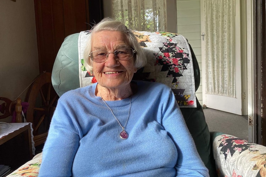 Brisbane resident 90-year-old Koosje Van Hameren sits in a chair in her home.