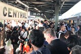 A crown of people on a train platform