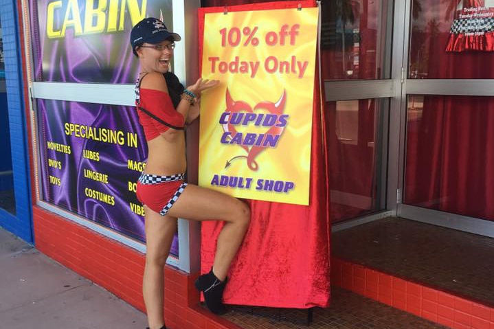 Female model poses outside Cupids Cabin Adult Shop in Townsville in north Queensland.
