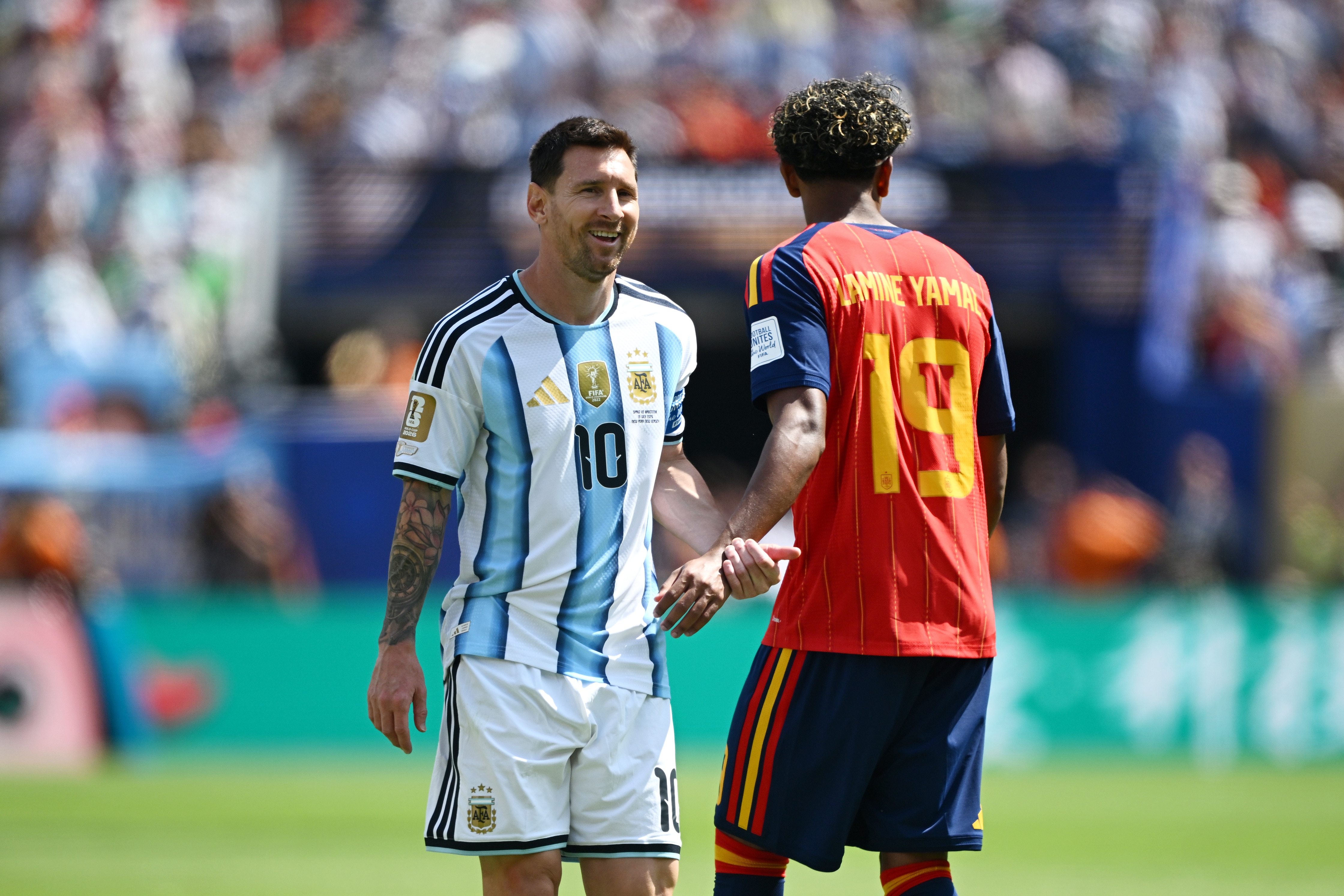 Two male soccer players talking.