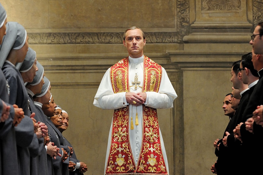 Jude Law surrounded by nuns in The Young Pope