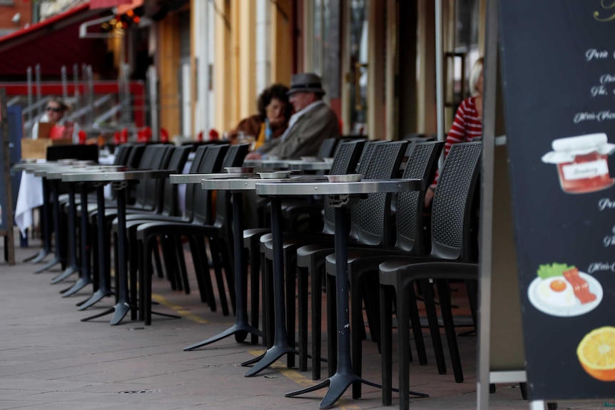 Tables and chairs at the front of a French restaurant