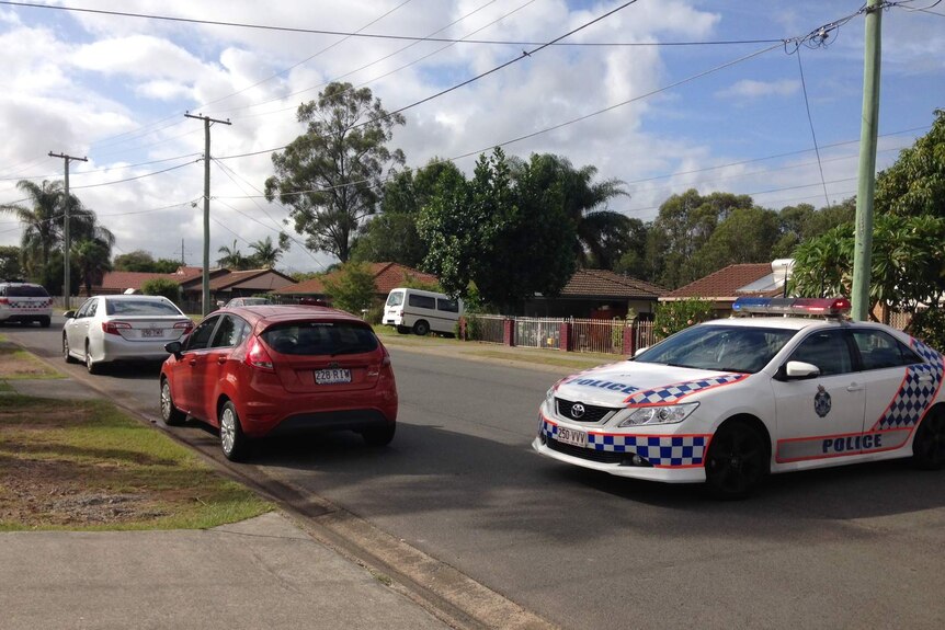 Police at the Kingston Street house, after the man was taken into custody.